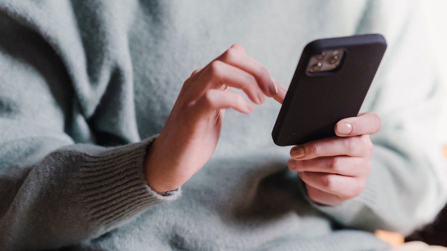 Telefoon in handen en aan het typen